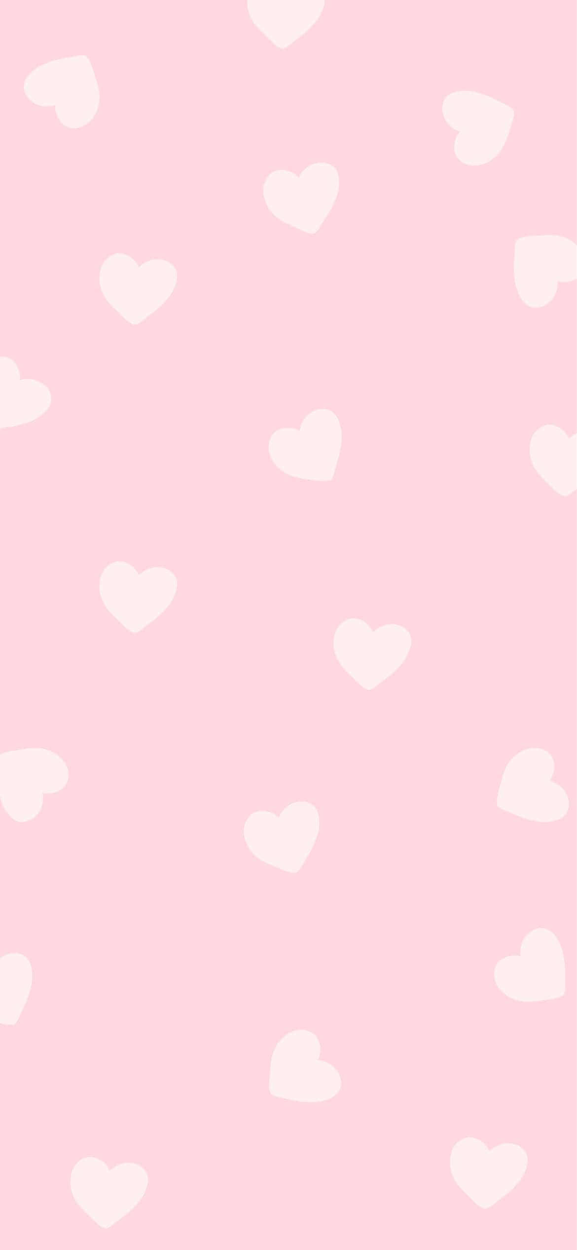 Розовый фон с белыми сердечками Обои