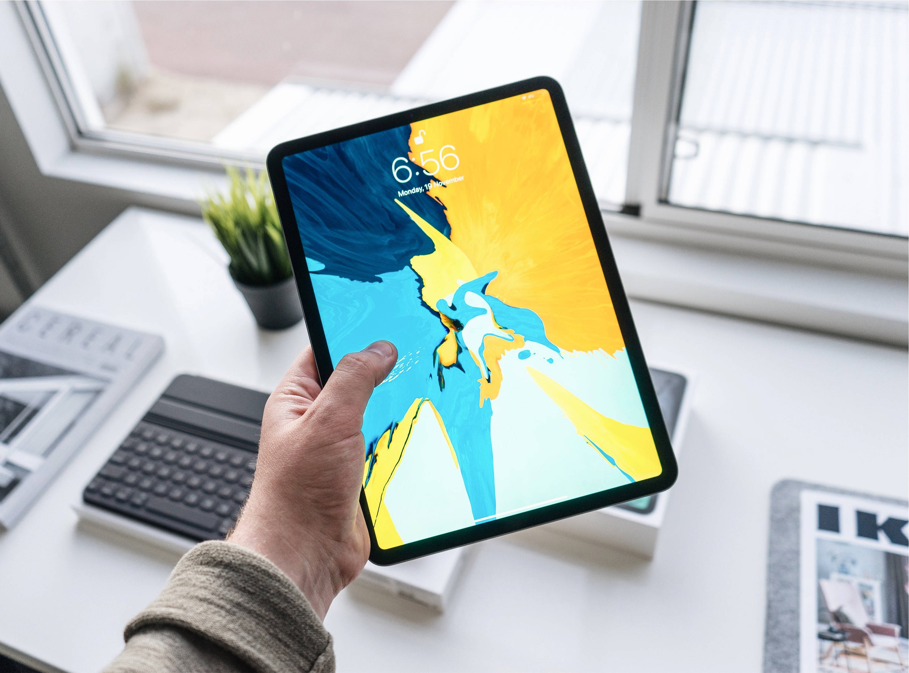 Человек, держащий Apple iPad Pro Обои
