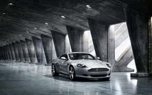 Aston Martin DB9, путешествующий по живописному городскому пейзажу — Steam Deck OLED Обои