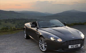 Подпись: Элегантный Aston Martin DB9 на дороге — MacBook Air M1 Обои